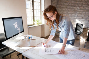 female contractor working on building plans